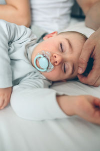 Family sleeping on bed at home