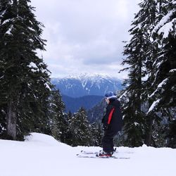 Tourists walking on snow covered landscape