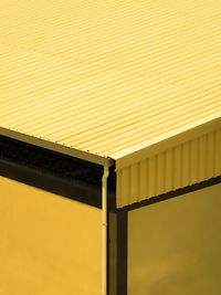 Low angle view of yellow bridge against sky during sunset