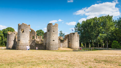 Old ruins on field against sky