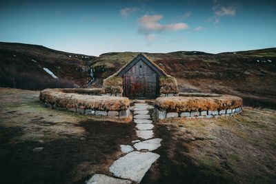 Built structure on land against sky