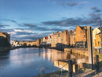 Panoramic view of river by city against sky