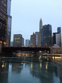 Illuminated cityscape against clear sky