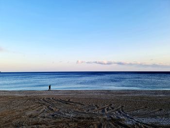 Scenic view of sea against clear blue sky