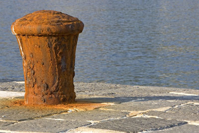 Close-up of old wooden post on beach