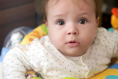 Close-up portrait of cute baby at home