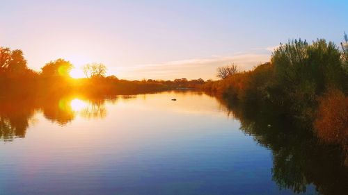 Scenic view of lake at sunset