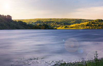 Scenic view of lake against sky during sunset