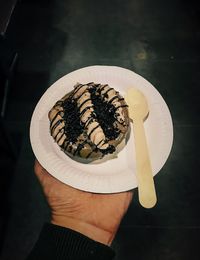 High angle view of hand holding cake