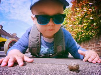 Child looking at a snail