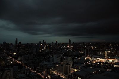 High angle view of illuminated cityscape against sky at dusk