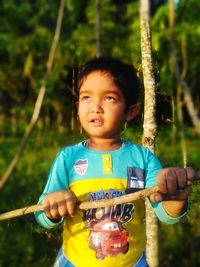 Portrait of boy holding camera