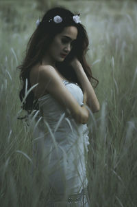 Beautiful young woman in field