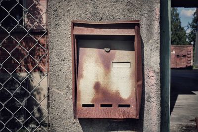 Close-up of old mailbox on building