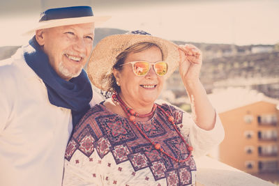 Happy senior couple looking at view during sunny day