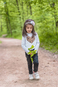 Portrait of cute girl standing on land