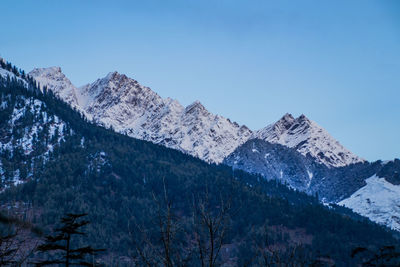 Scenic view of snowcapped mountains against clear blue sky