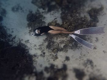 Freediver girl laying on the sand