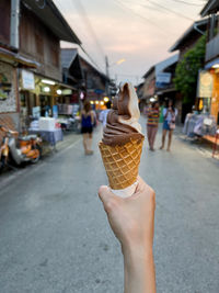 Female hand holding chocolate ice cream