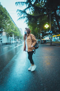 Full length of woman walking on street in city