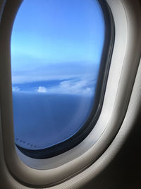 Aerial view of sea seen through airplane window