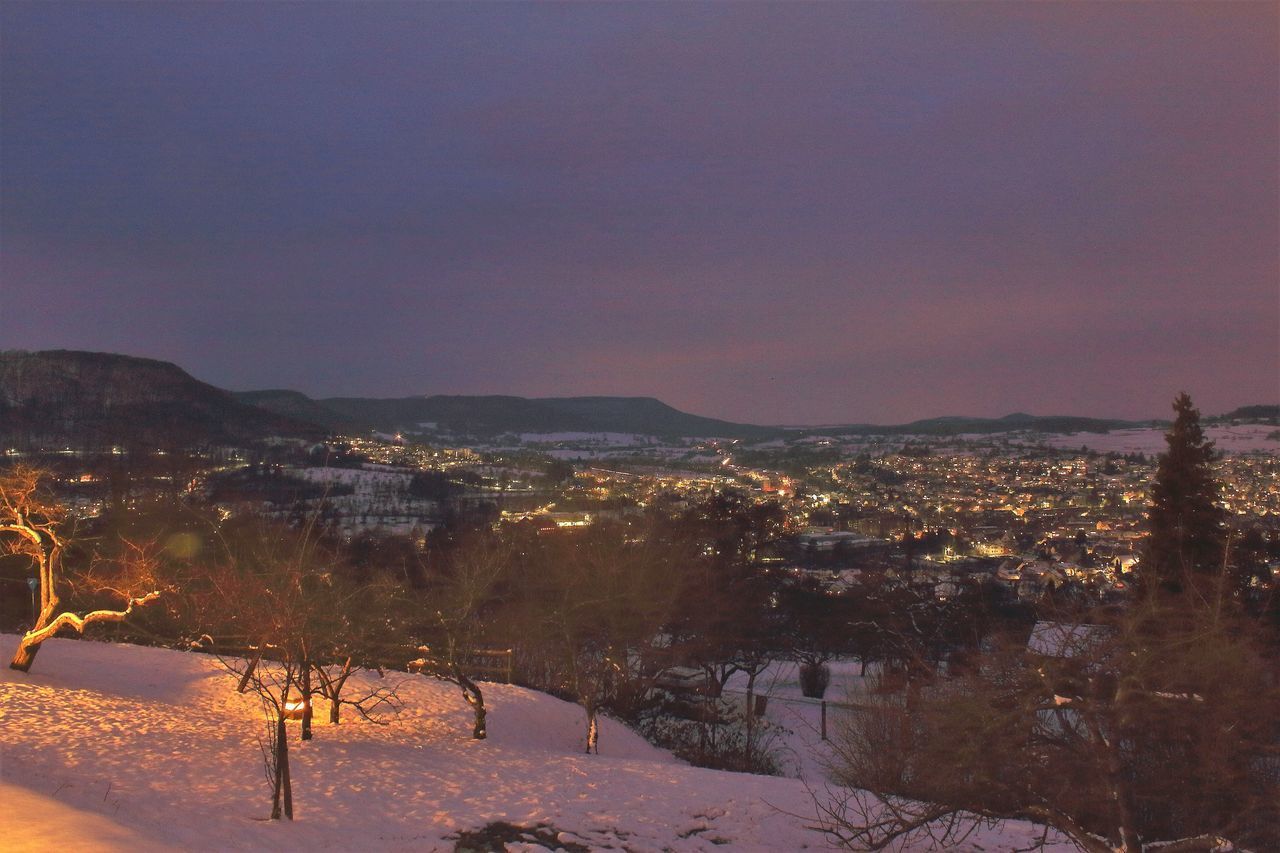 AERIAL VIEW OF ILLUMINATED CITY DURING WINTER