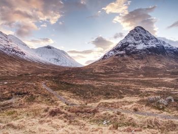 Winter scotland highlands. scenic view of snowcapped mountains against sky