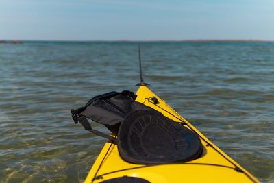 Yellow kayak on sea against sky