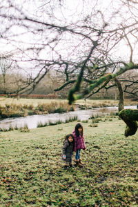 Women in forest by lake during winter