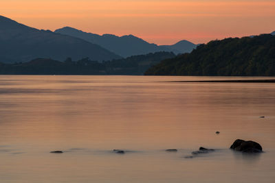 Scenic view of lake against sky during sunset