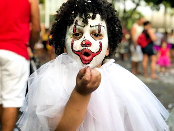 Close-up portrait of boy with painted face