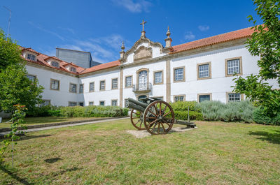 Bicycle by building against sky