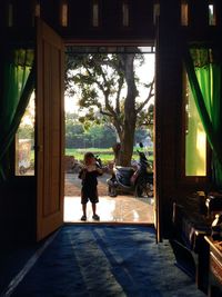 Full length of boy standing at entrance