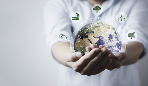 Midsection of woman holding globe