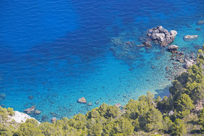 High angle view of rocks on sea shore