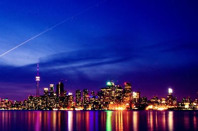 Illuminated modern buildings in city at night