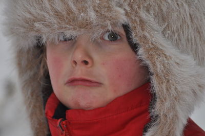 Close-up portrait of boy wearing fur hat