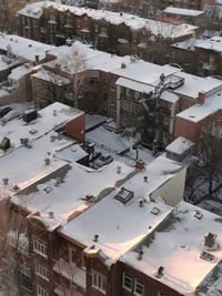 High angle view of snow covered houses in city