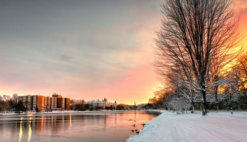 Snow covered landscape at sunset