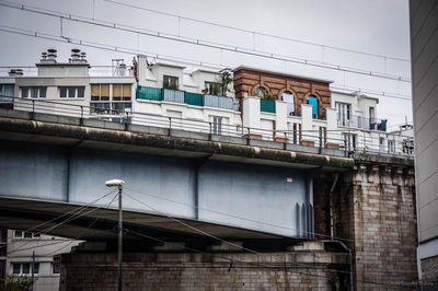 View of bridge and buildings against sky