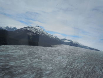 Scenic view of snow covered mountains against sky