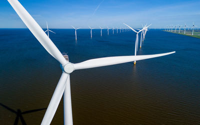 Low angle view of windmill against sky