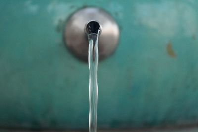 Close-up of water dripping from faucet on wall