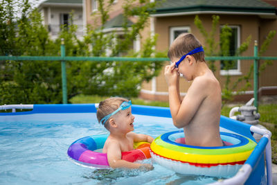 Shirtless boy swimming in pool