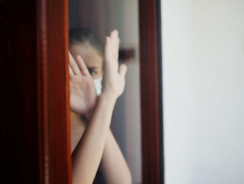 Midsection of woman holding glass window