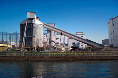 View of bridge over river against buildings