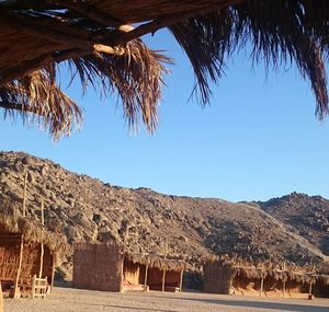 Scenic view of desert against clear blue sky