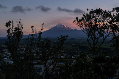 Scenic view of snowcapped mountains against sky at sunset