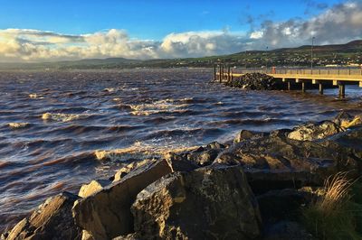 Scenic view of sea against cloudy sky