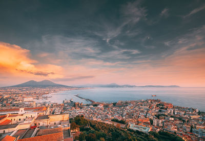 Aerial view of townscape against sky during sunset